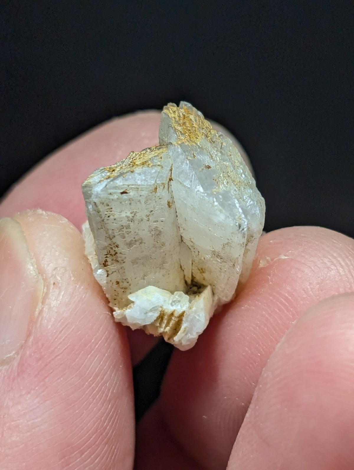 A translucent, crystalline mineral specimen with golden metallic inclusions.