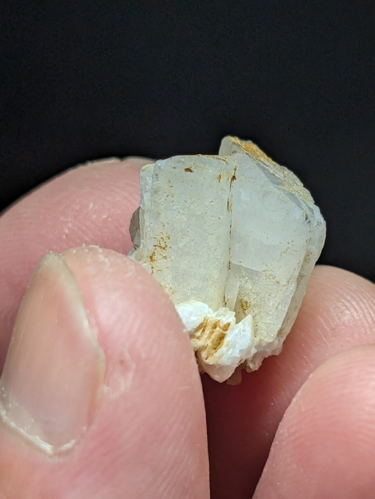 A translucent, pale quartz crystal cluster with subtle golden mineral inclusions.