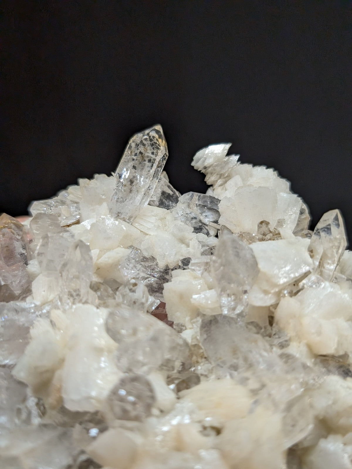 A cluster of clear, translucent quartz crystals with some exhibiting subtle white and gray inclusions.