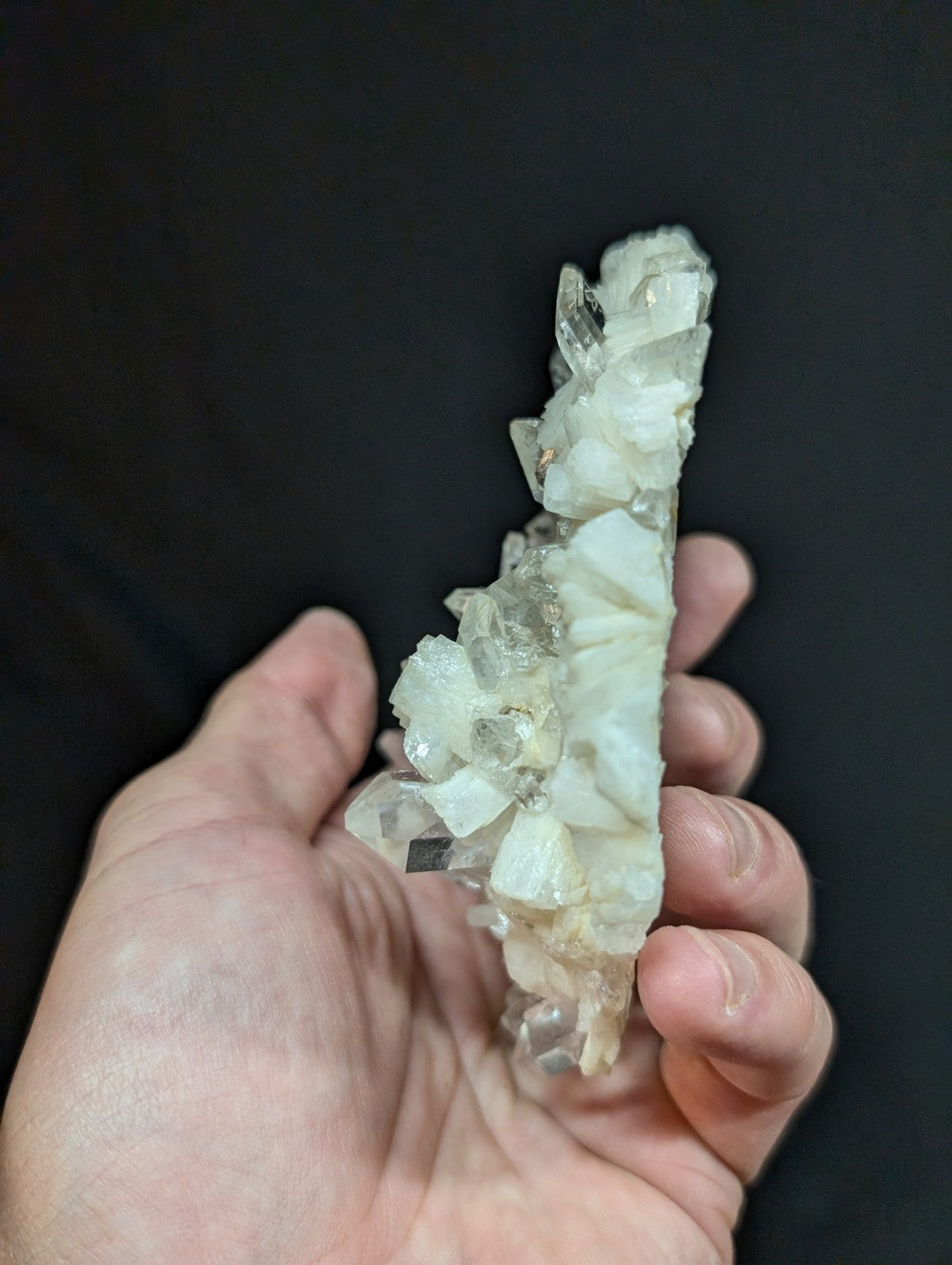 A translucent, pale quartz crystal cluster with a natural, jagged growth pattern.