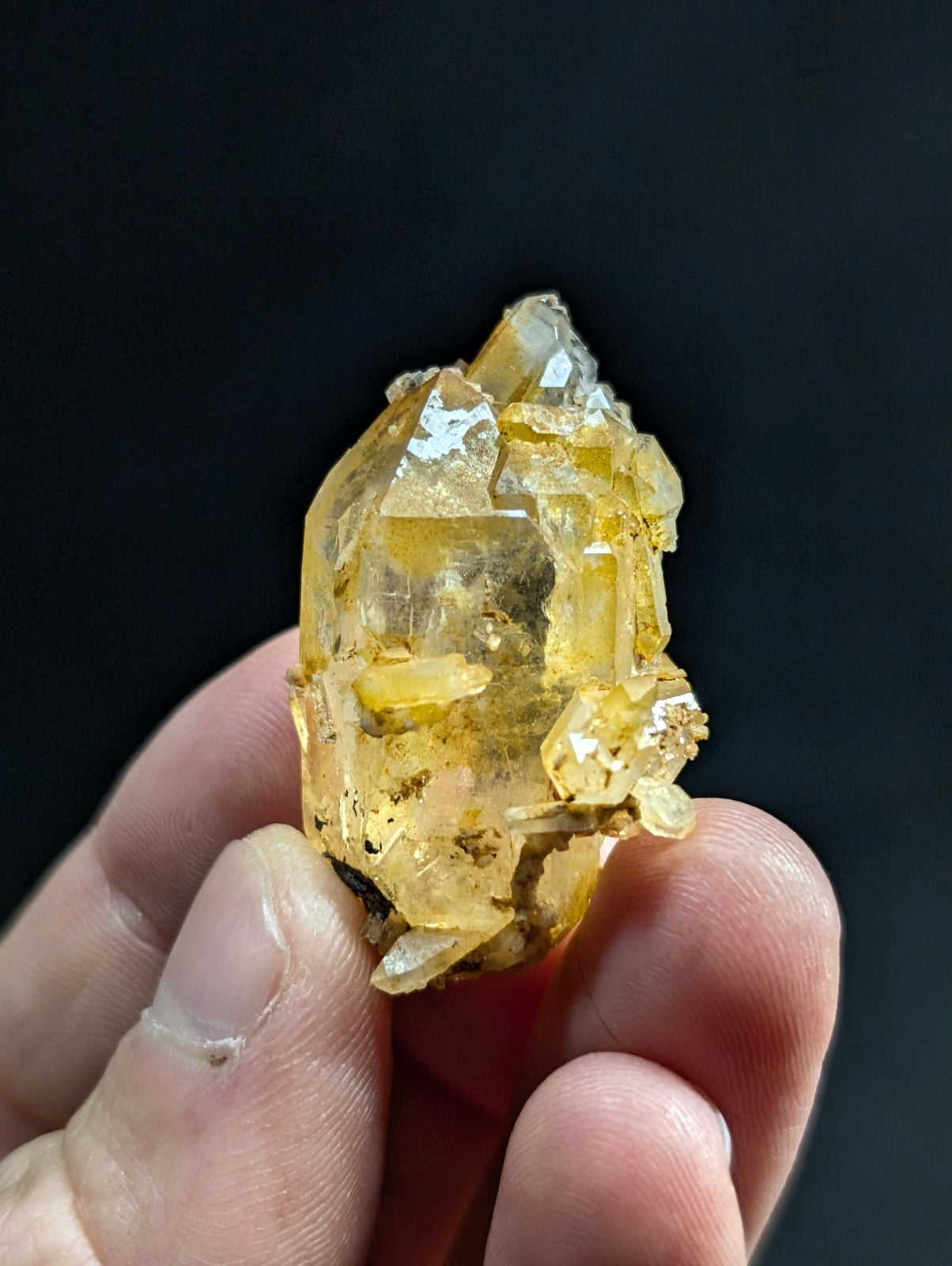 A translucent yellow crystal cluster with sharp, faceted edges and a natural, earthy texture.
