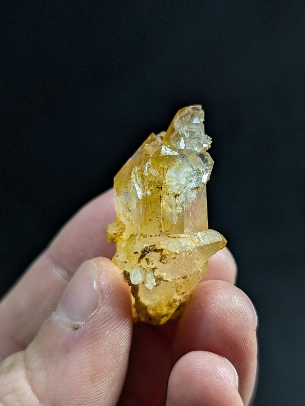 A translucent golden-yellow crystal cluster with sharp, faceted edges and a natural, irregular growth pattern.