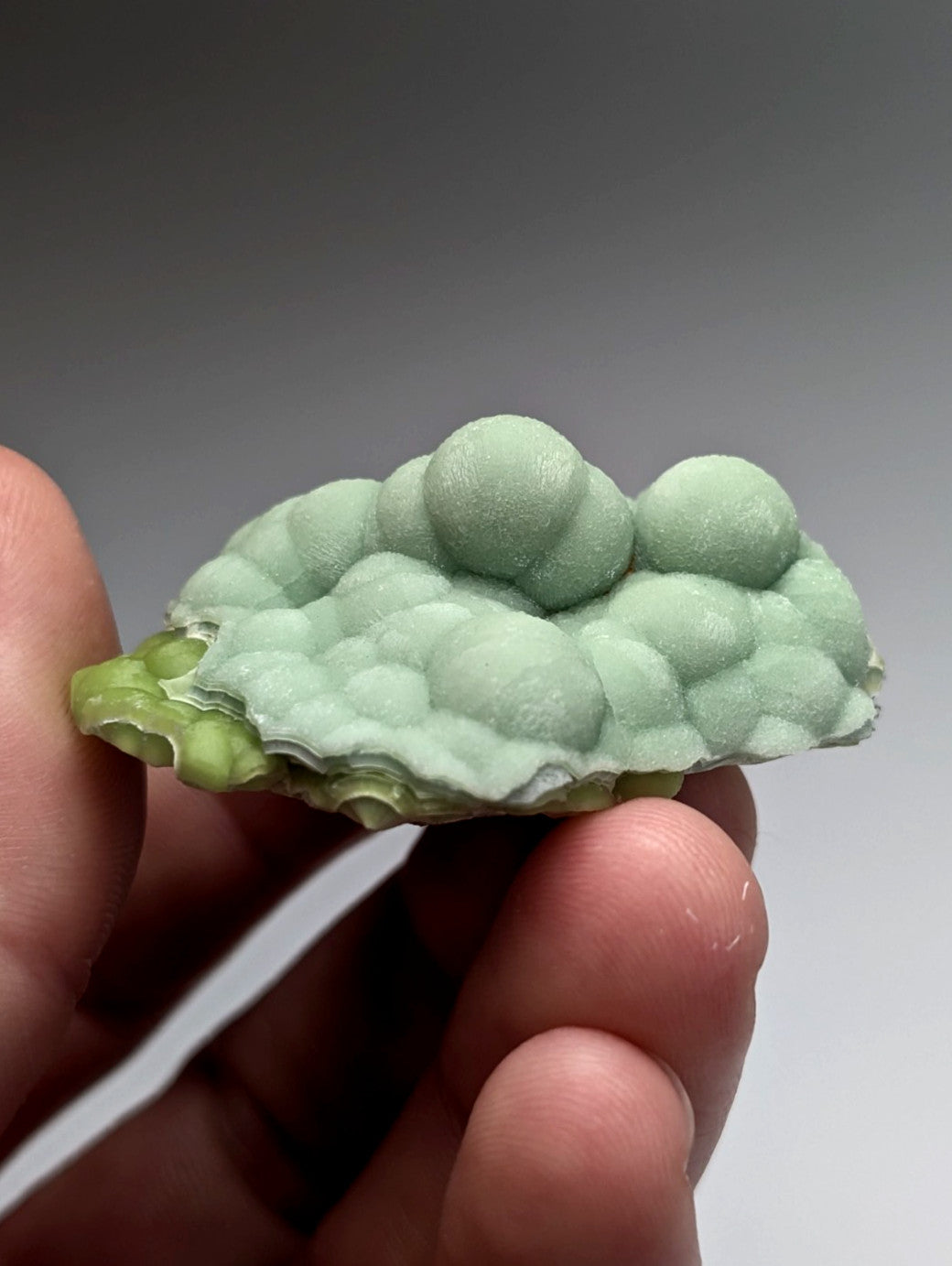 A delicate pale green 3d-printed wavellite mineral specimen with textured rounded bubbles from mauldin mountain arkansas