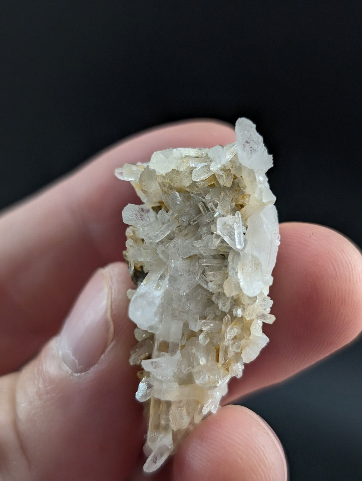 A translucent, pale yellowish-white crystal cluster with sharp, interlocking facets and a natural, irregular growth pattern.