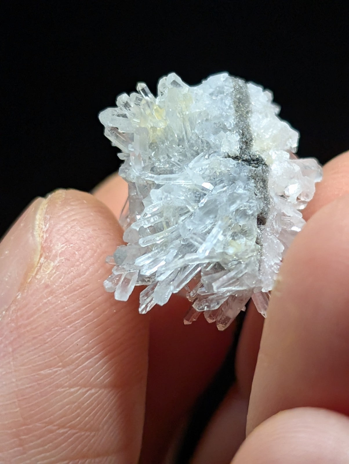 A translucent, crystalline mineral specimen with sharp, interlocking facets and a pale blue tint.
