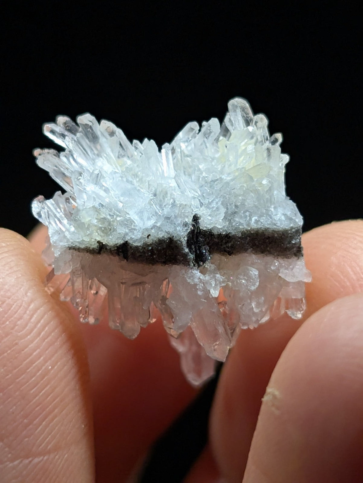 A translucent, crystalline mineral specimen with sharp, jagged facets and a pale blue tint.