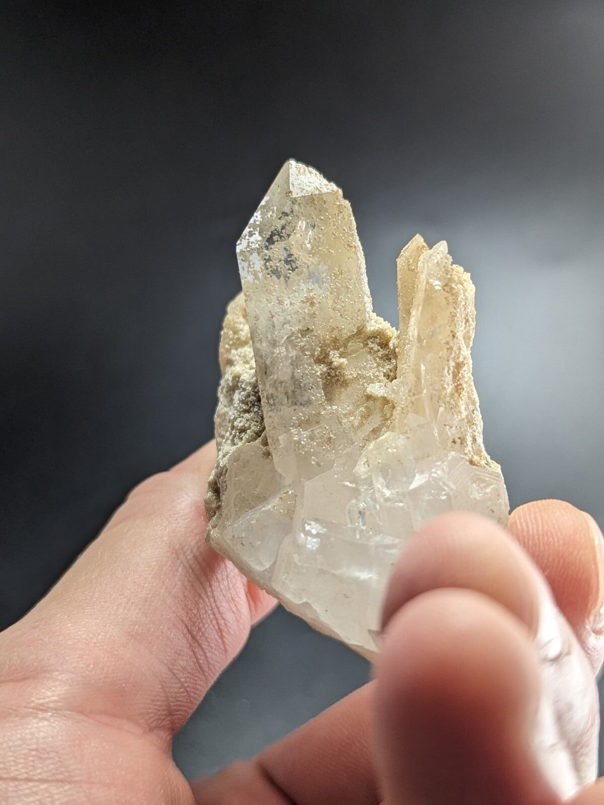 A translucent, pale quartz crystal cluster with sharp facets and a slightly cloudy base.