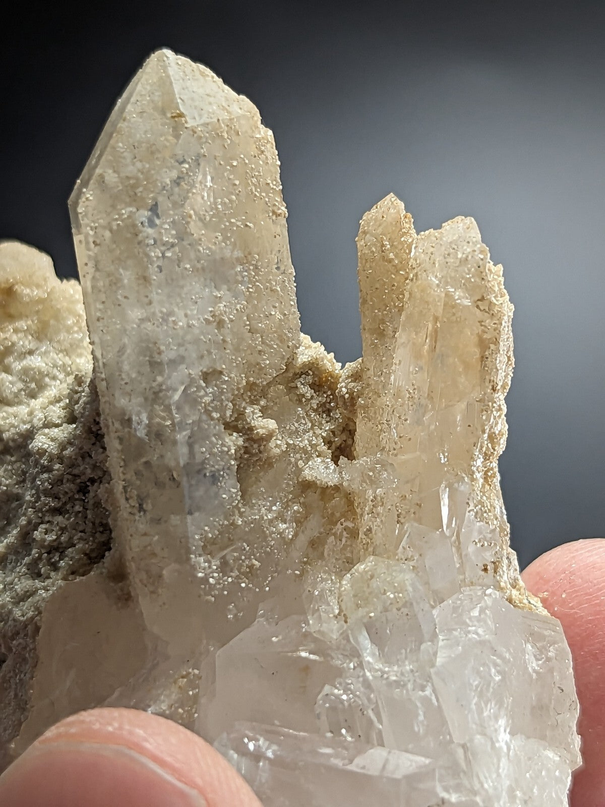 A translucent, pale quartz crystal cluster with sharp, pointed formations and a slightly cloudy texture.