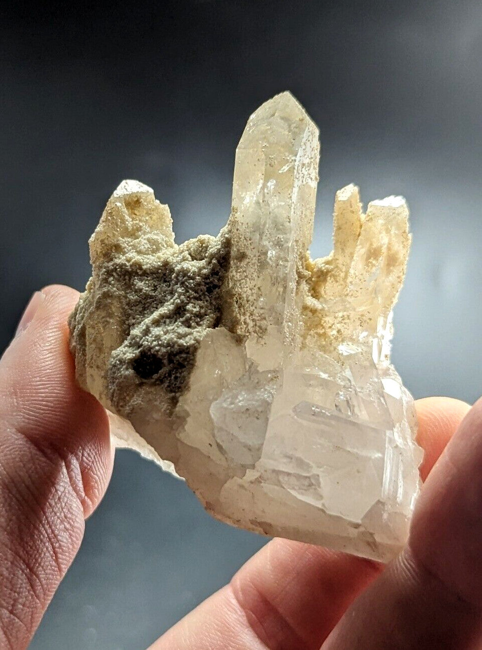 A translucent, pale quartz crystal cluster with sharp facets and a slightly cloudy appearance.