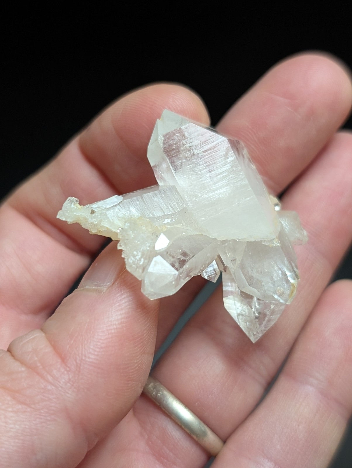 A translucent, pale quartz crystal cluster with sharp facets and a slightly milky appearance.
