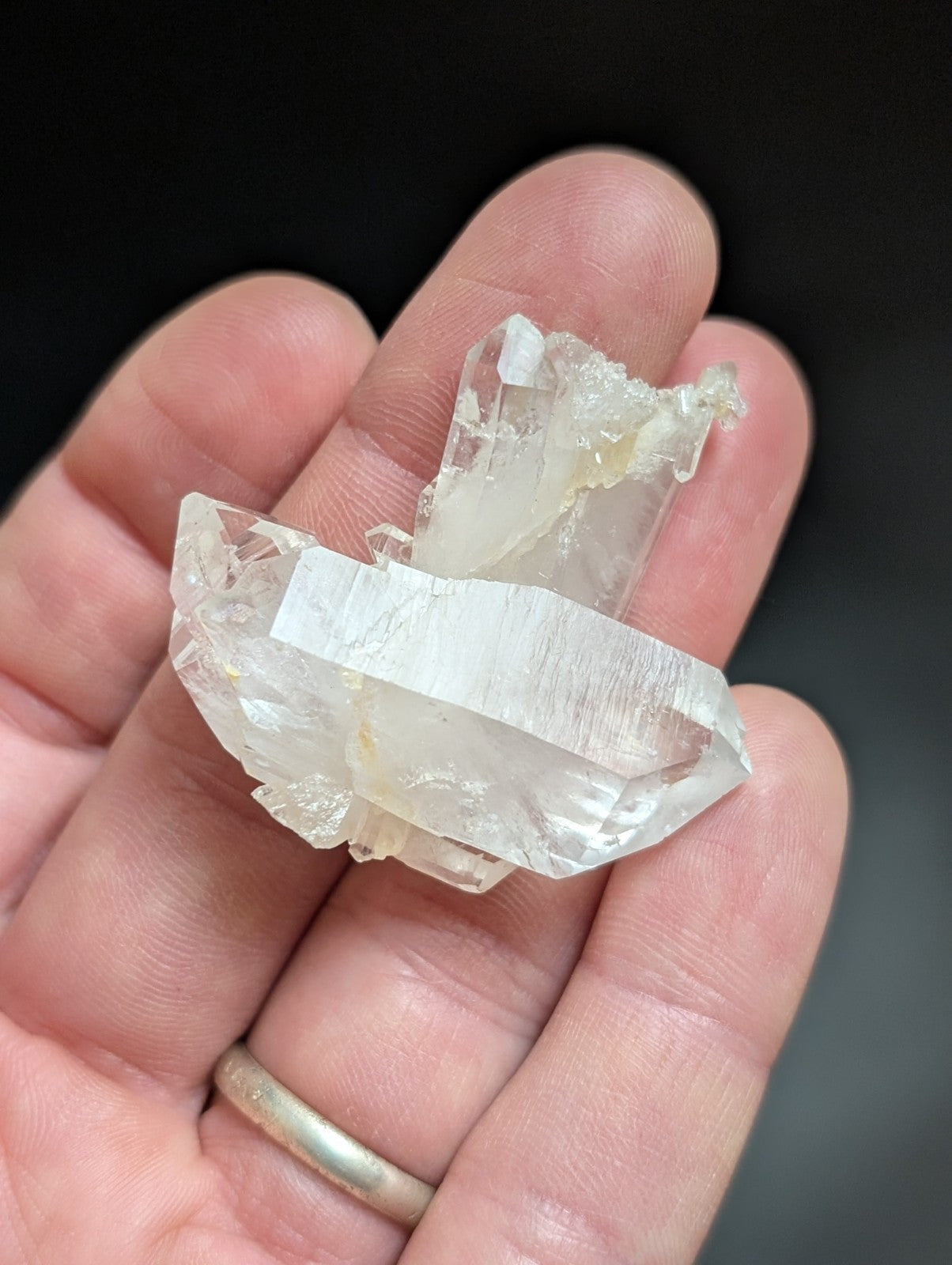 A translucent, clear quartz crystal cluster with jagged edges and a natural, raw appearance.
