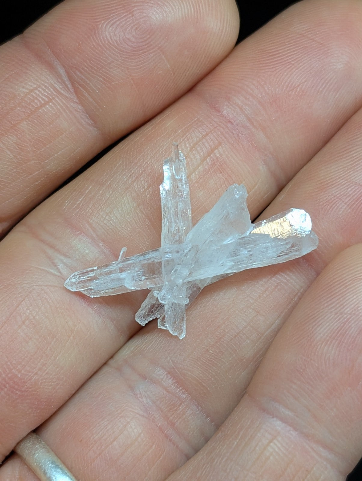 A clear, translucent quartz crystal cluster with sharp, angular facets and a natural, irregular growth pattern.