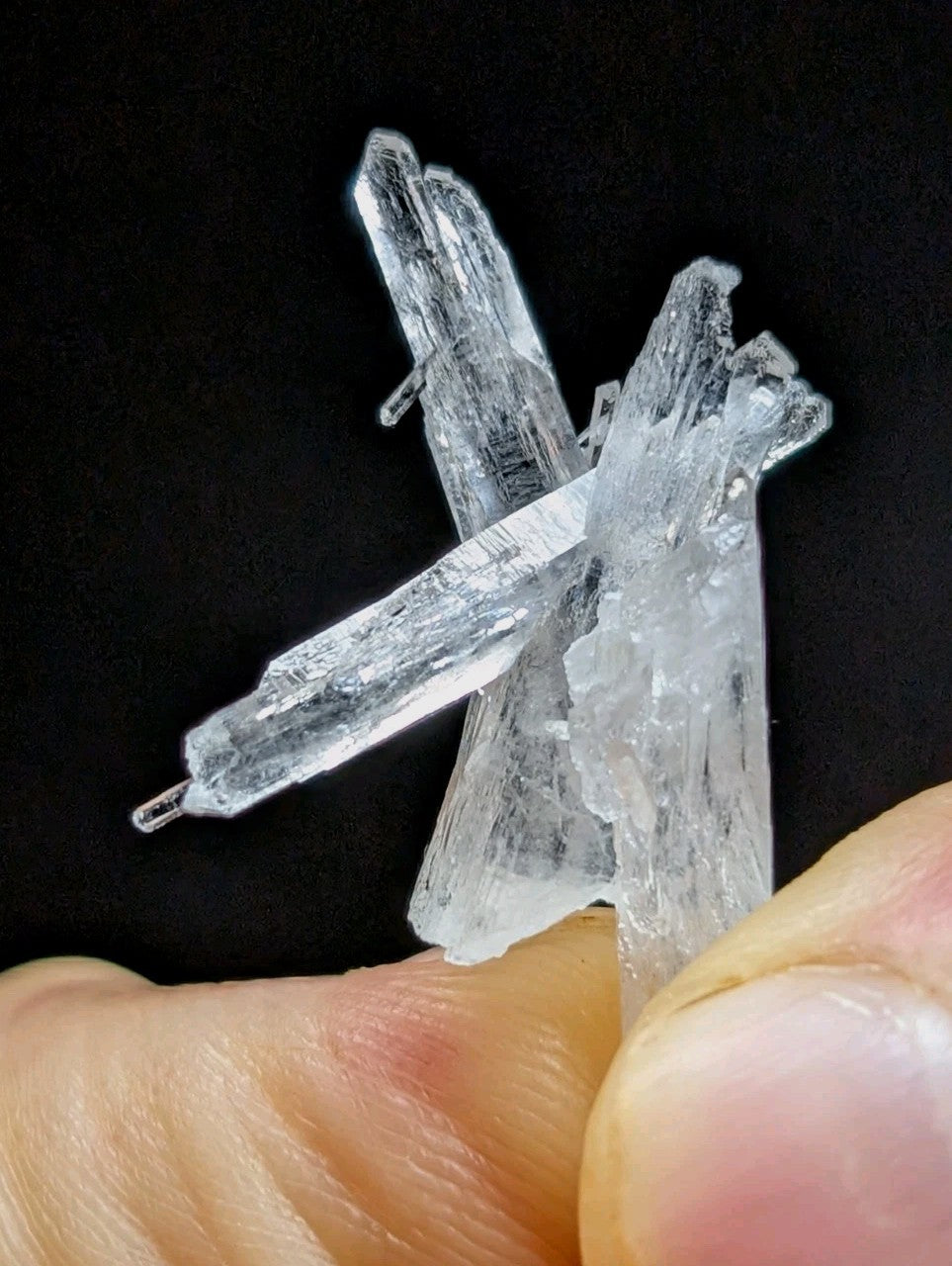 Clear, translucent quartz crystal cluster with jagged edges and intersecting prismatic formations.