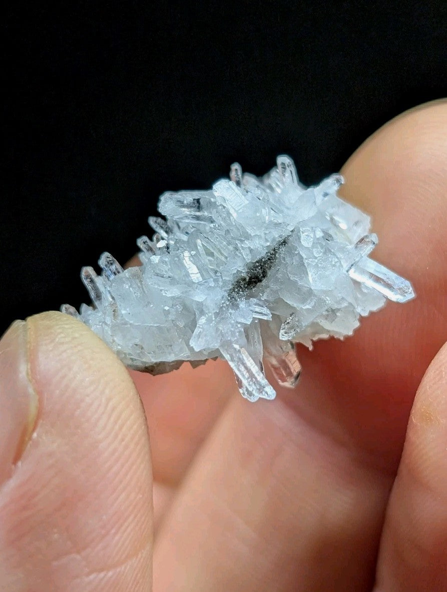 A translucent, crystalline quartz cluster with sharp, interlocking facets and a pale blue tint.