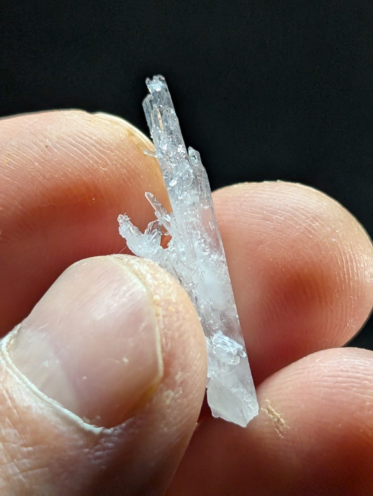 A translucent, clear quartz crystal cluster with jagged edges and a pointed tip.