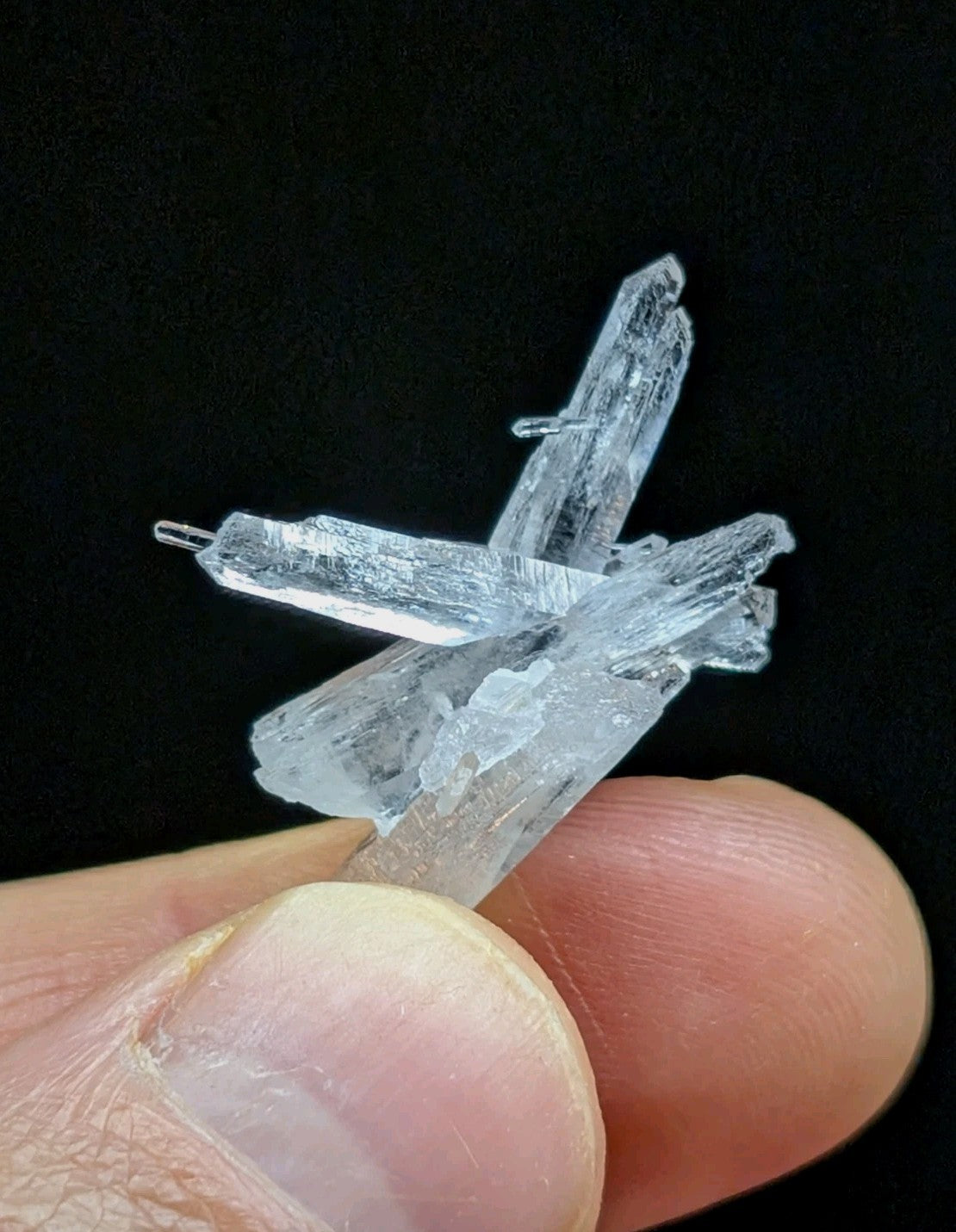 A translucent, crystalline mineral specimen with sharp, angular facets and a pale blue tint.
