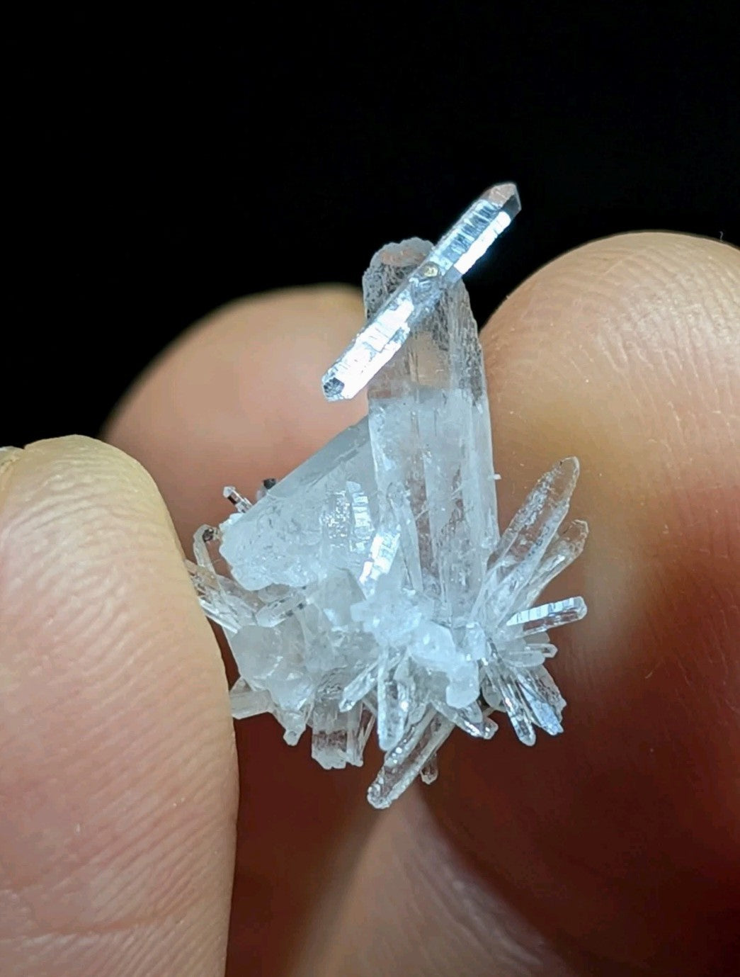 A translucent, crystalline mineral specimen with sharp, angular facets and a pale blue tint.