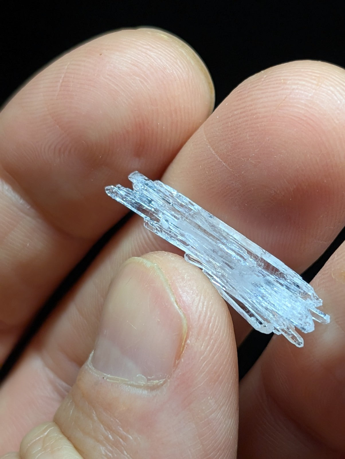 A translucent, crystalline mineral specimen with jagged edges and a pale blue tint.