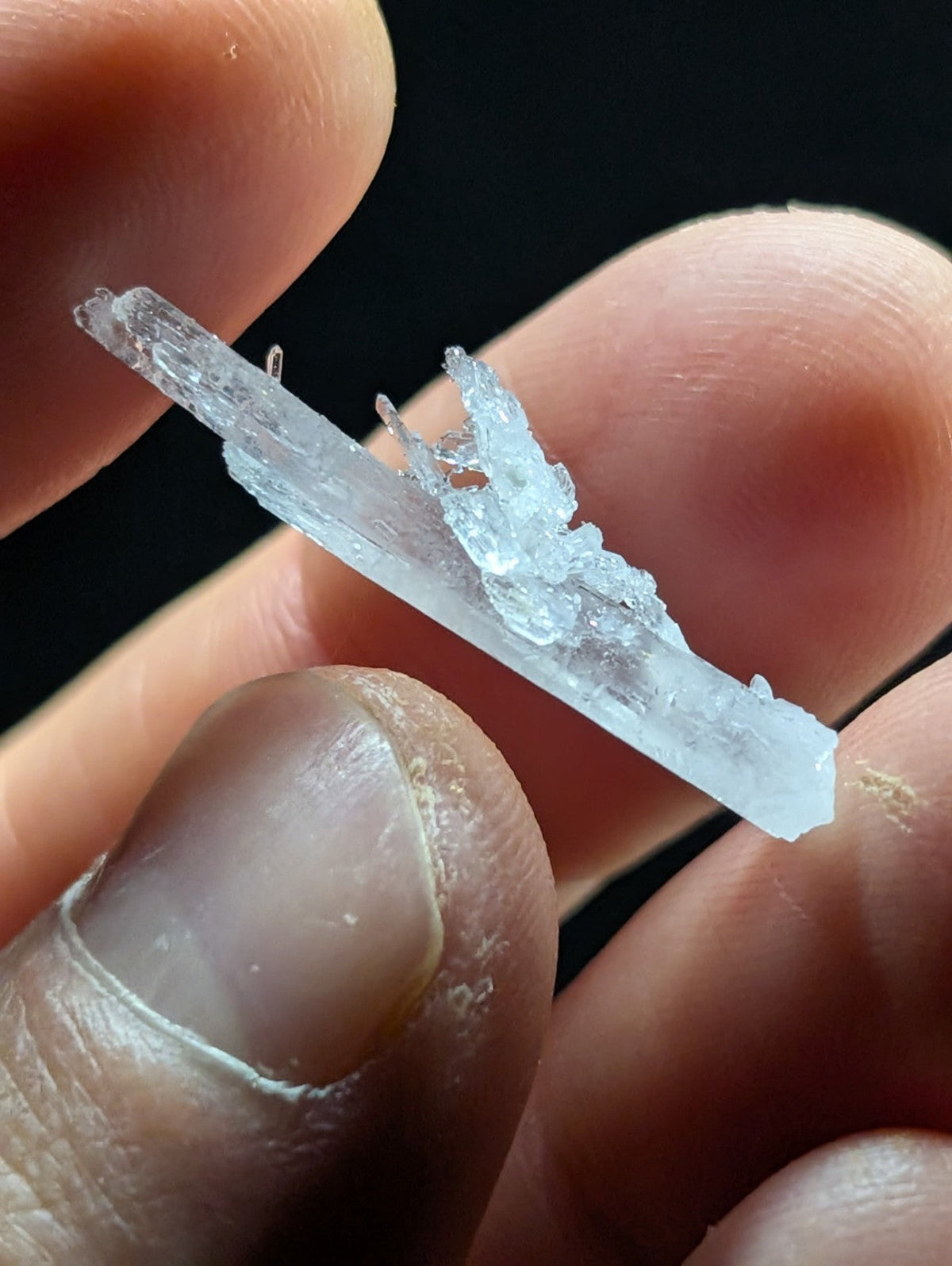 A translucent, crystalline mineral specimen with jagged edges and a slightly cloudy appearance.