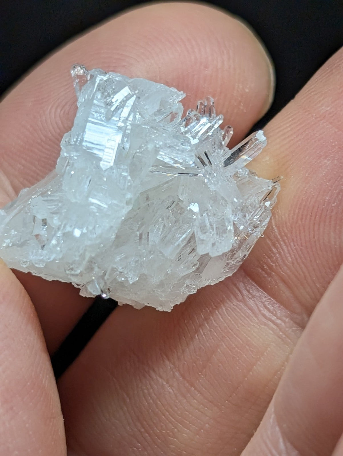 A translucent, crystalline mineral specimen with sharp, faceted edges and a pale blue tint.