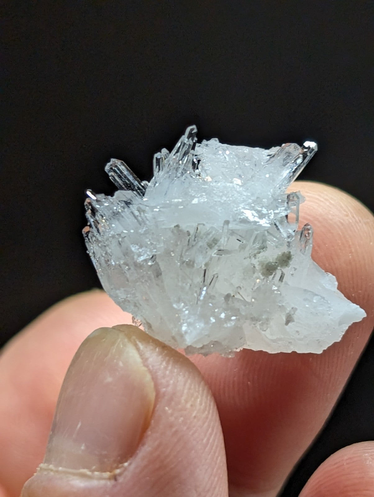 A translucent, crystalline mineral specimen with sharp, jagged facets and a pale blue tint.
