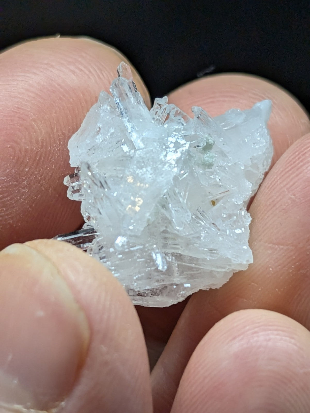 A translucent, crystalline mineral specimen with sharp, jagged edges and a pale blue tint.