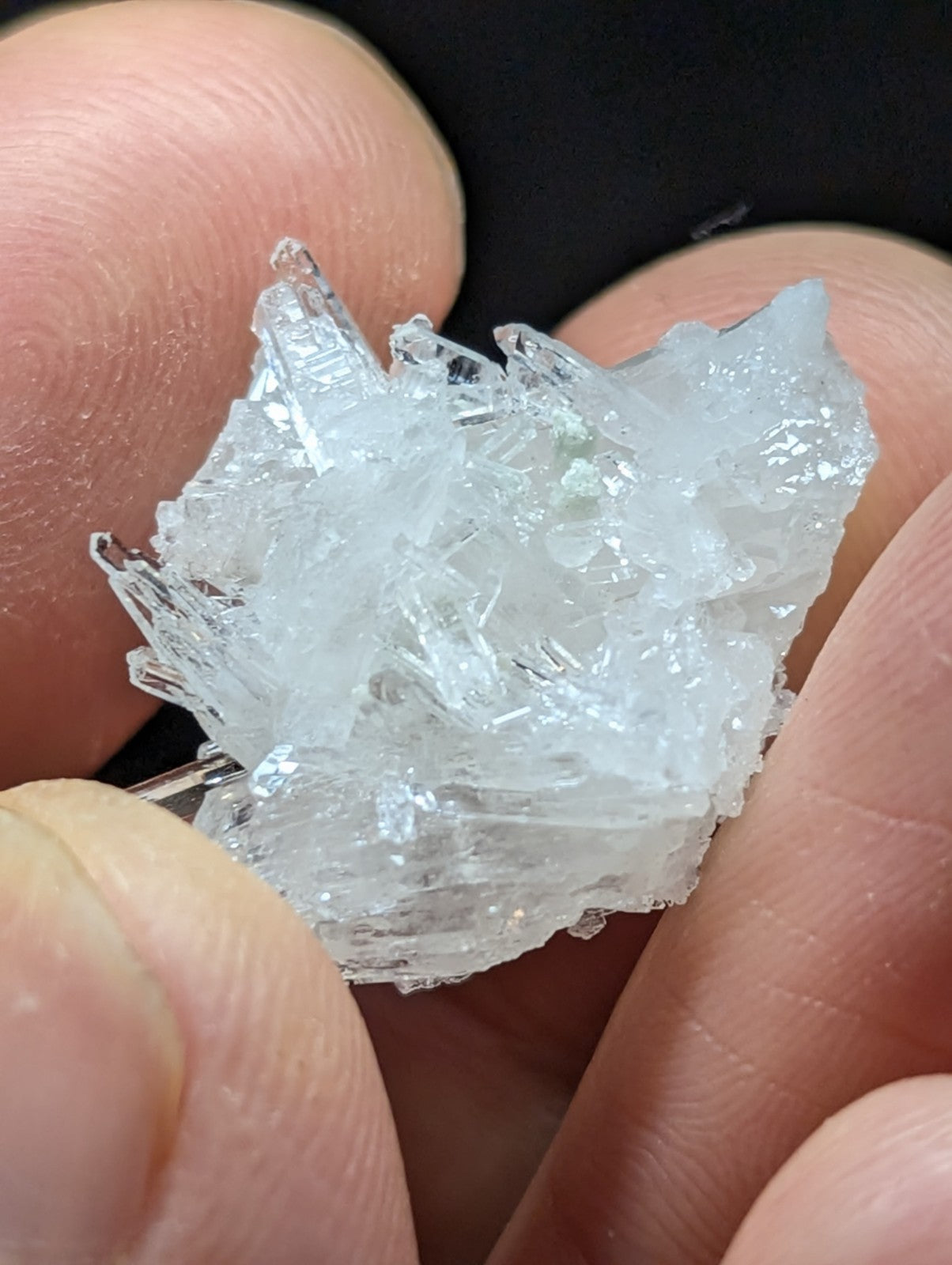 A translucent, crystalline mineral specimen with sharp, jagged edges and a pale, icy white hue.