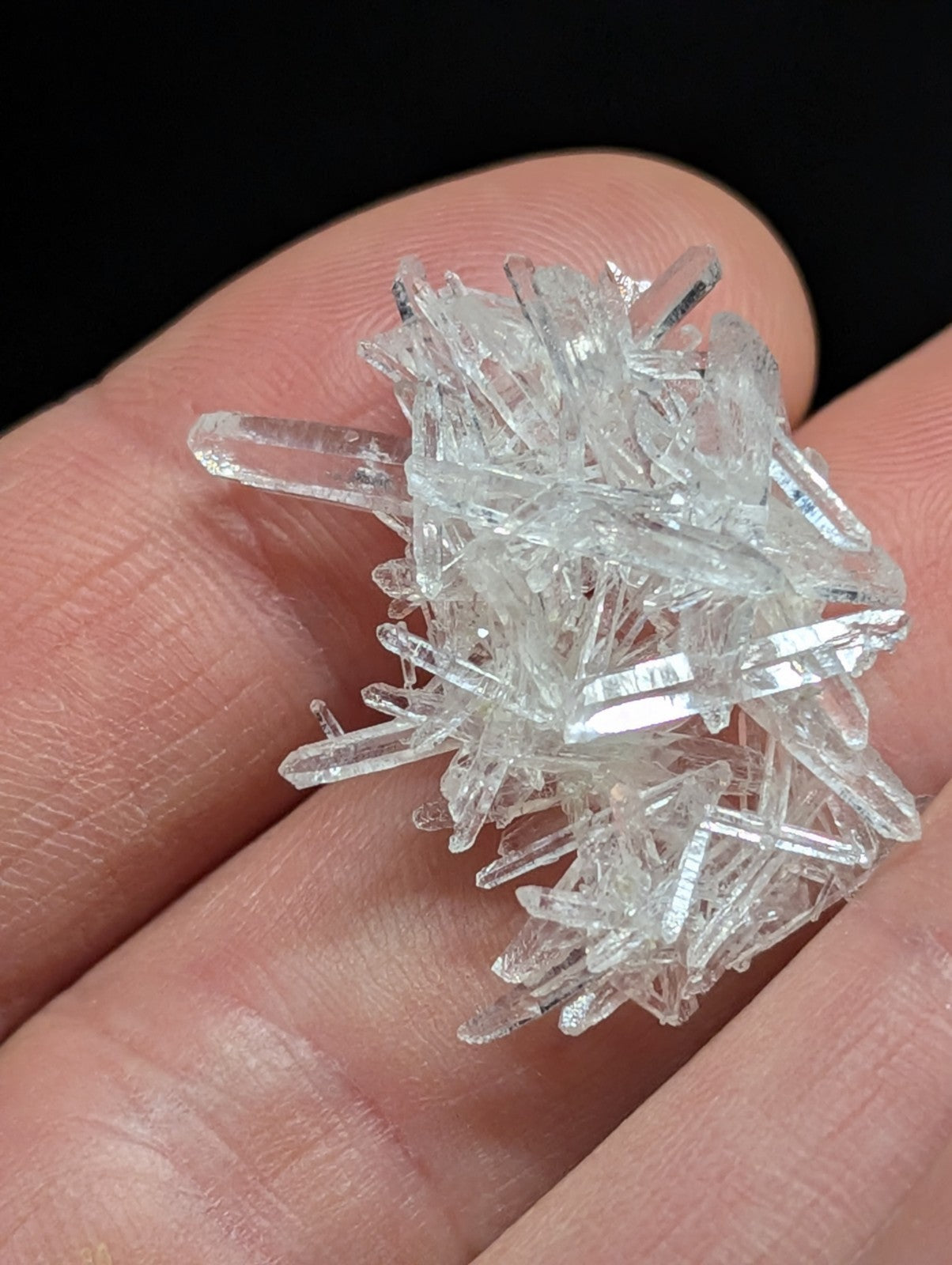 A cluster of clear, transparent quartz crystals with sharp, faceted edges and a natural, irregular growth pattern.