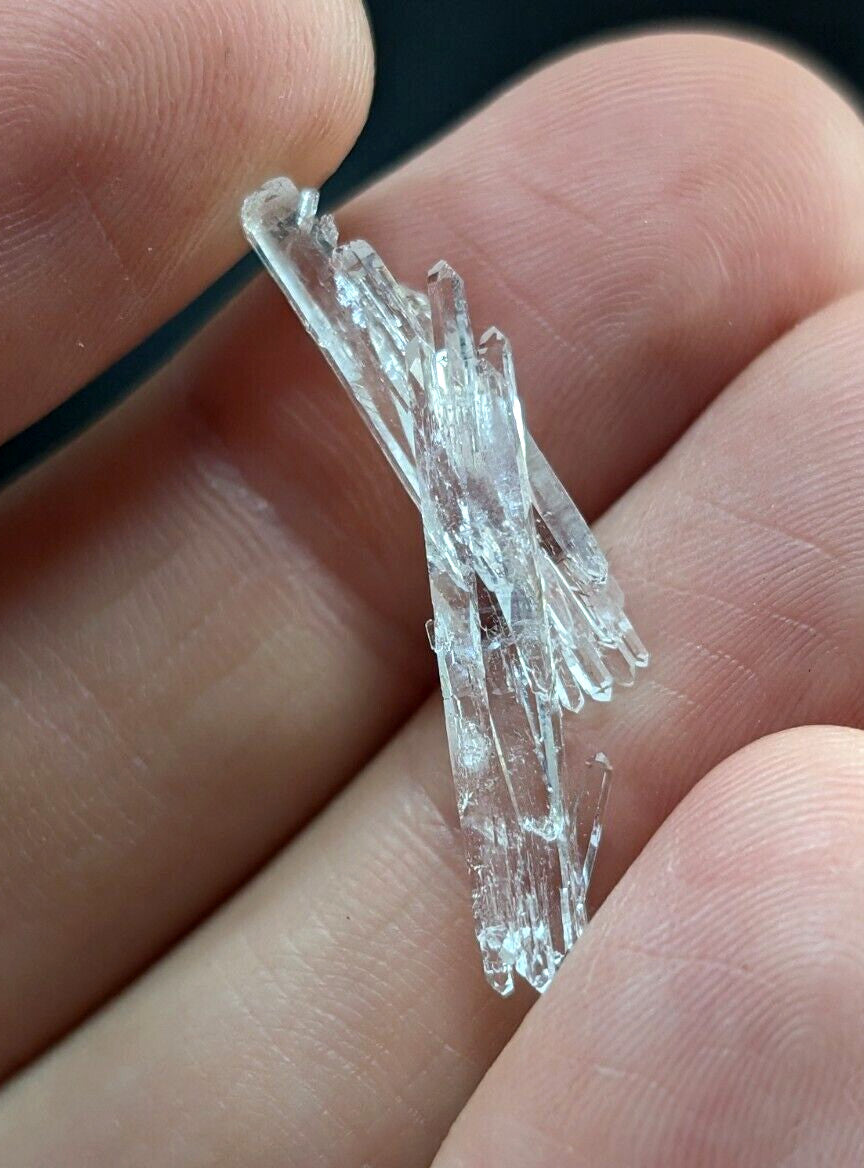 A cluster of clear, translucent quartz crystals with sharp, jagged edges and a natural, irregular growth pattern.
