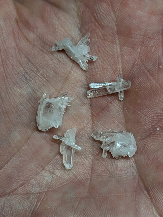 Clear quartz crystals with jagged, translucent edges and natural facets.