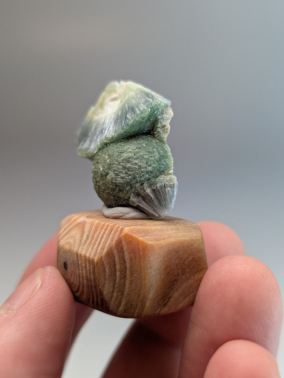 Green and white wavellite mineral specimen with textured layers mounted on handmade wood base from garland county arkansas