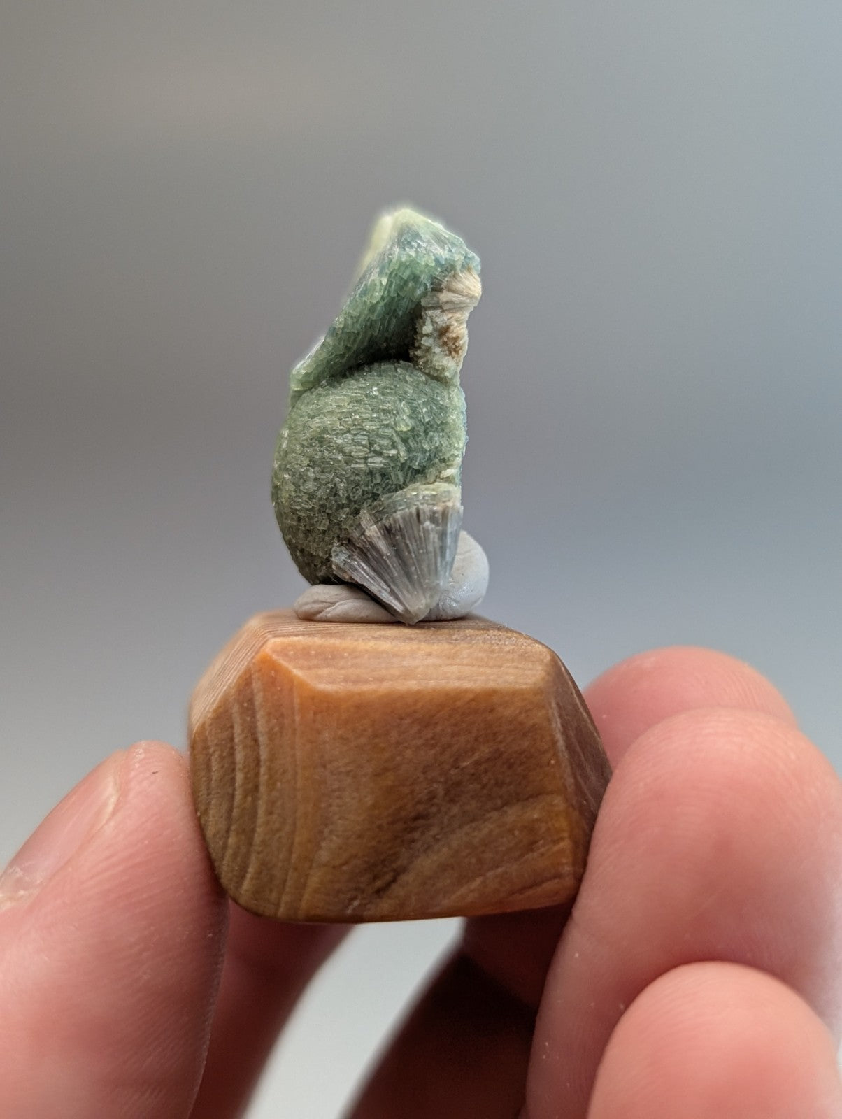 Amazing wavellite with a small carved green jade rabbit figurine on a handmade polished wood mount from Arkansas