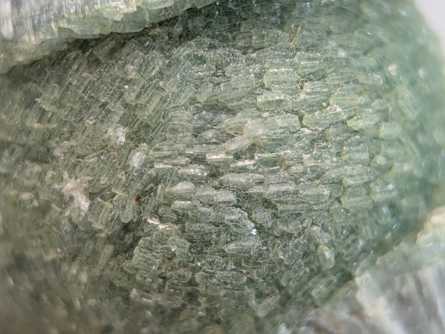 Translucent green wavellite mineral specimen with crystalline layered texture on handmade wood mount from arkansas