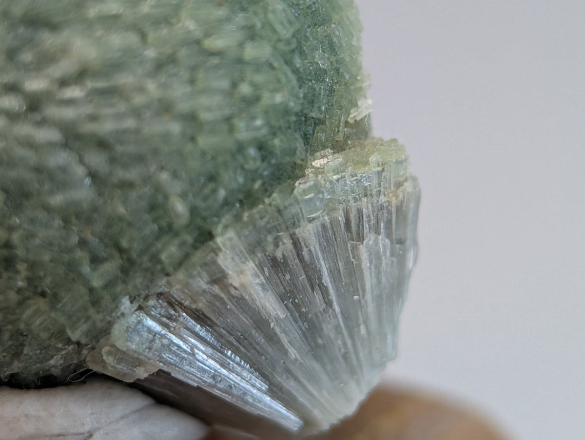 Amazing wavellite translucent green mineral with textured crystalline surface and radiating formations on handmade wood mount