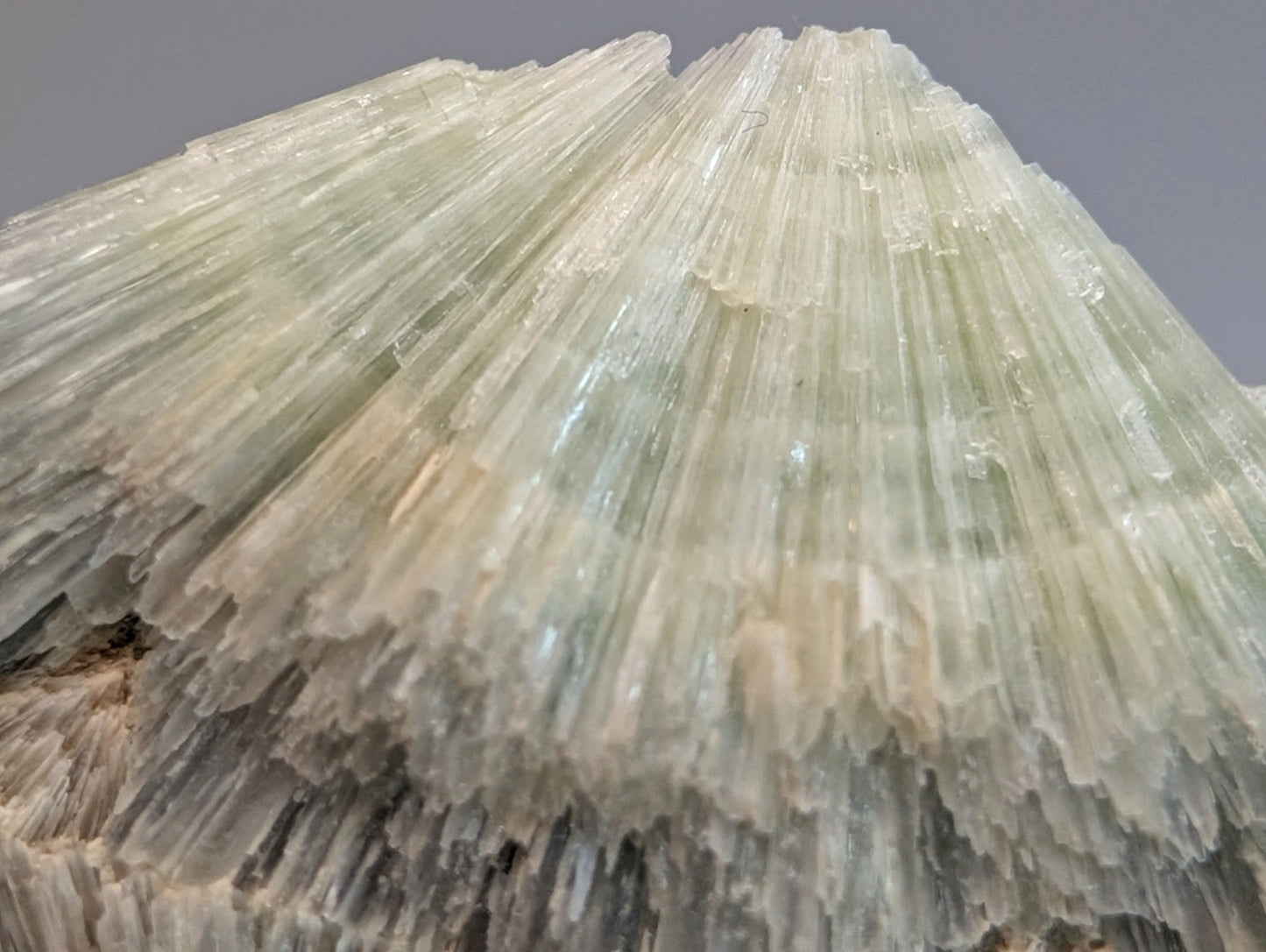 Amazing wavellite mineral specimen with pale green translucent layered needle crystals on handmade wood mount