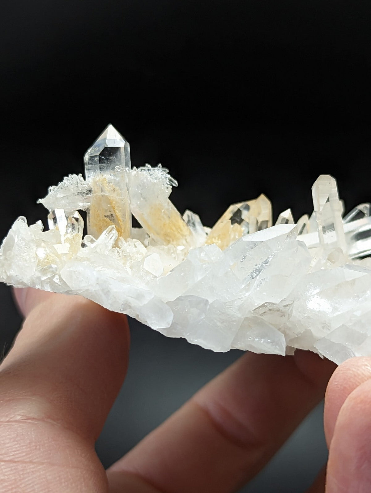 A translucent quartz crystal cluster with clear and golden-yellow crystals forming a natural, jagged formation.