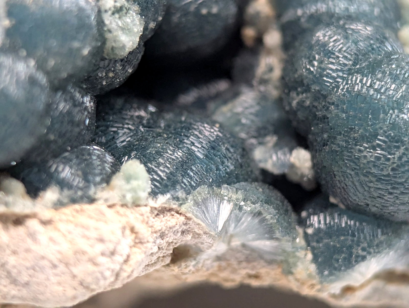 Deep teal-blue, textured mineral crystals with a crystalline surface.