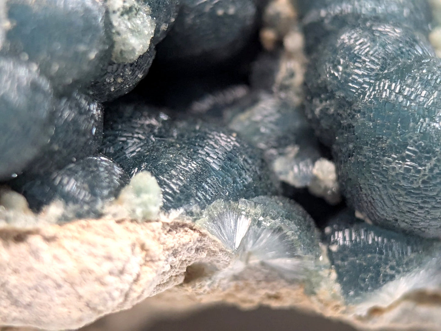 Deep teal-blue, textured mineral crystals with a crystalline surface.
