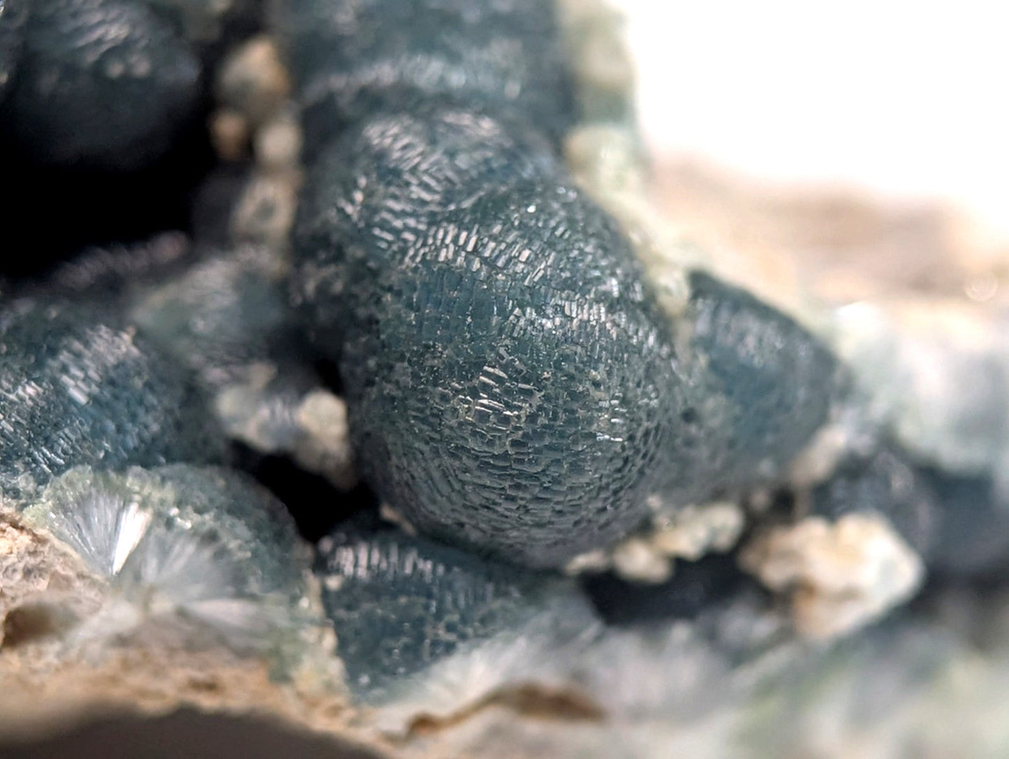 Dark blue, textured mineral formations with a crystalline surface.