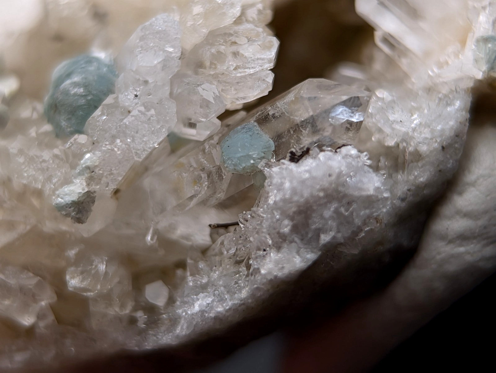 A cluster of translucent quartz with two small blue-green cookeite gemstones from saline county arkansas old stock uv reactive