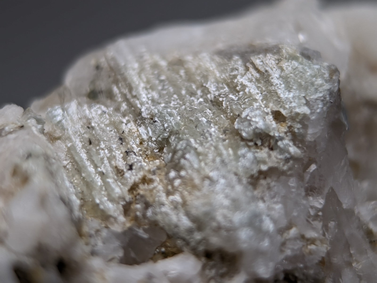 Blue-green cookeite on quartz mineral specimen with silver-gray crystalline texture and subtle golden flecks from arkansas