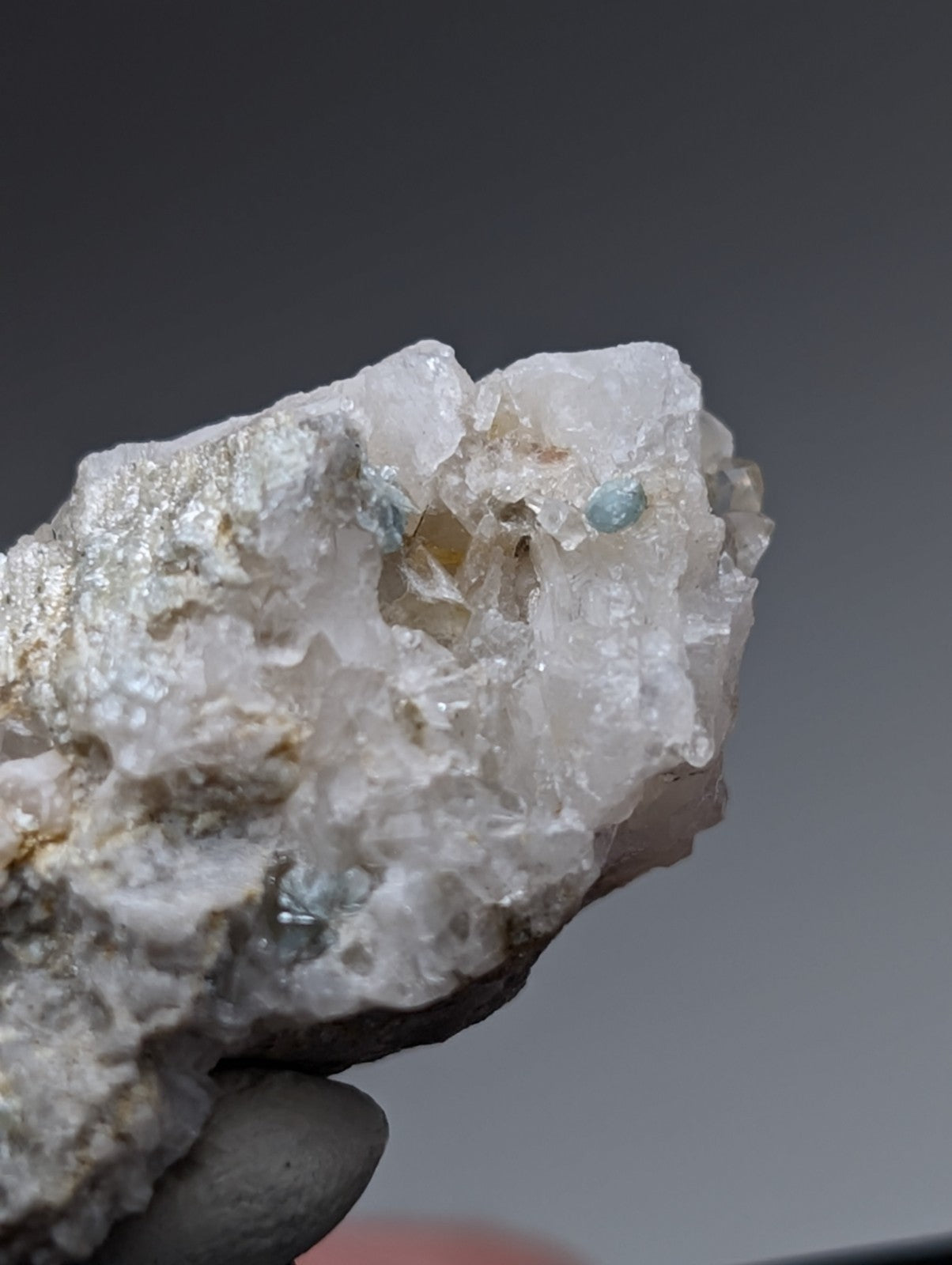 A translucent white quartz specimen with embedded light blue green cookeite gemstones from saline county Arkansas