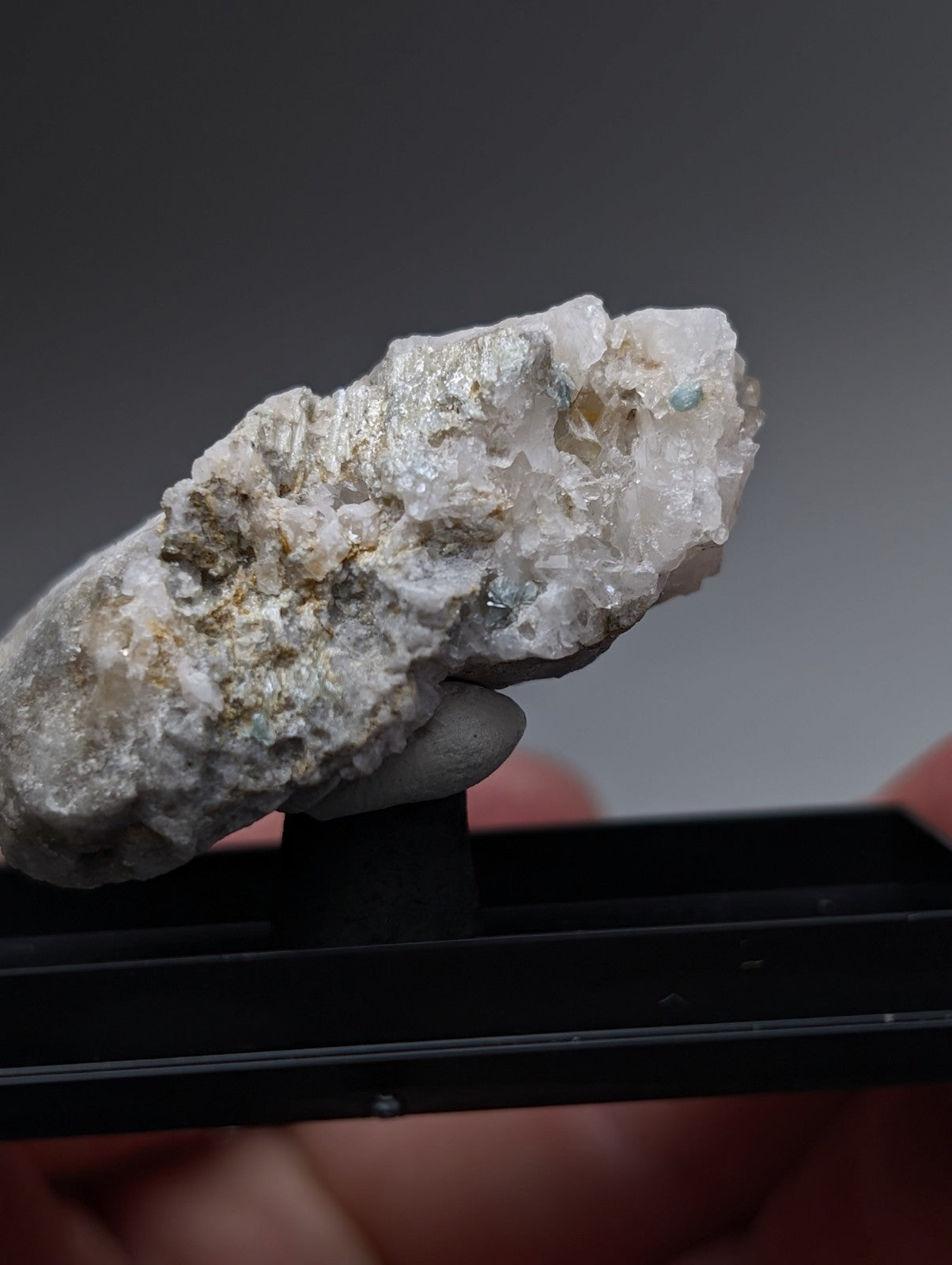 A textured blue-green cookeite on quartz mineral with white and metallic gold flecks from saline county arkansas uv reactive