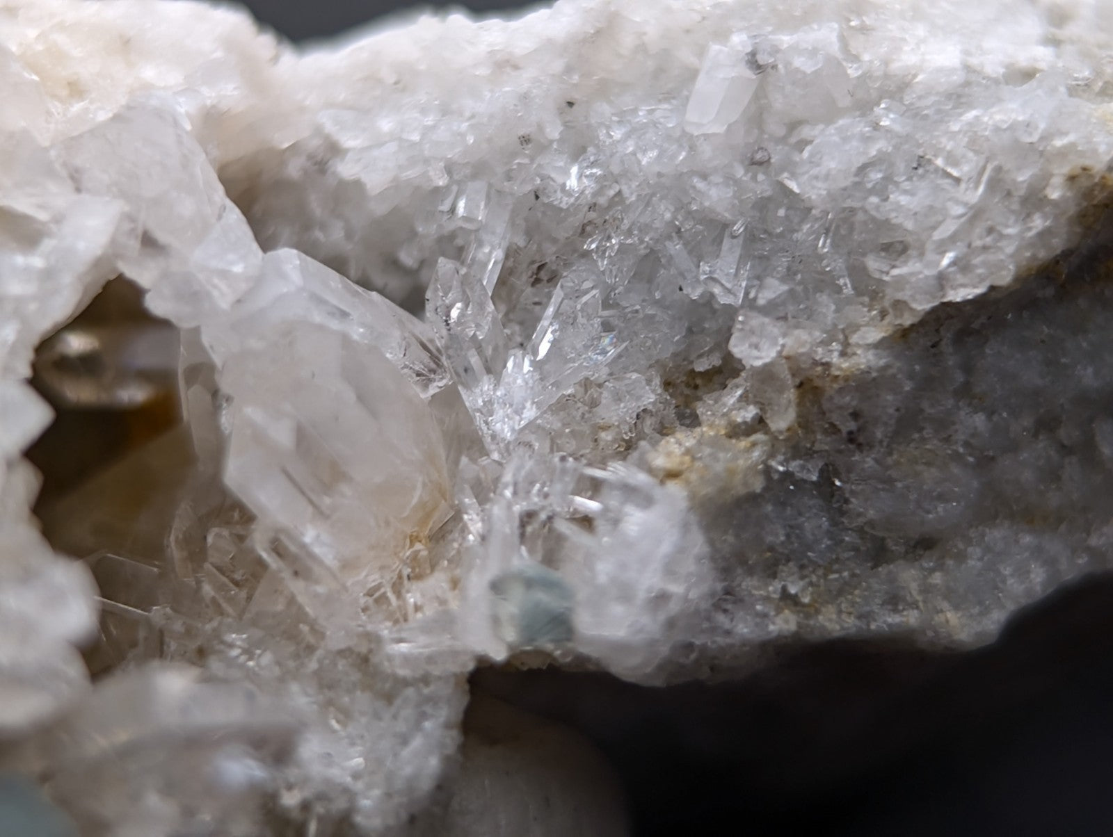 Clear translucent quartz crystals with sharp facets on rough gray matrix in blue-green cookeite on quartz from arkansas
