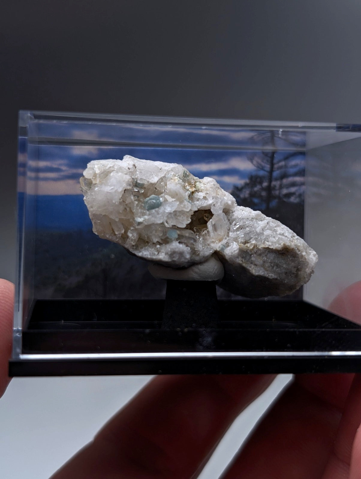 Blue-green cookeite on quartz translucent white mineral with blue and green inclusions in clear acrylic case from arkansas