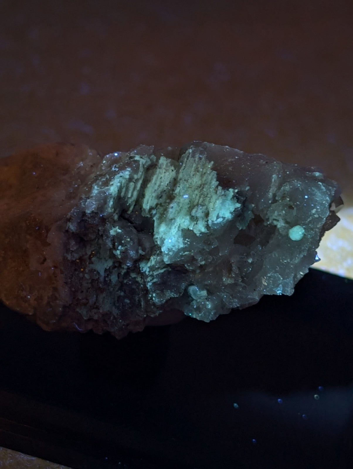 A translucent crystalline blue-green cookeite on quartz with dark and glowing turquoise hues from Saline County Arkansas