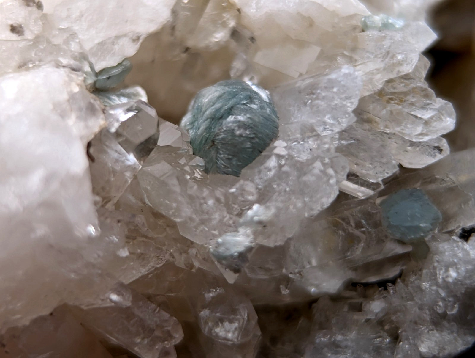 A cluster of translucent pale blue green cookeite crystals on clear quartz from saline county arkansas old stock UV reactive