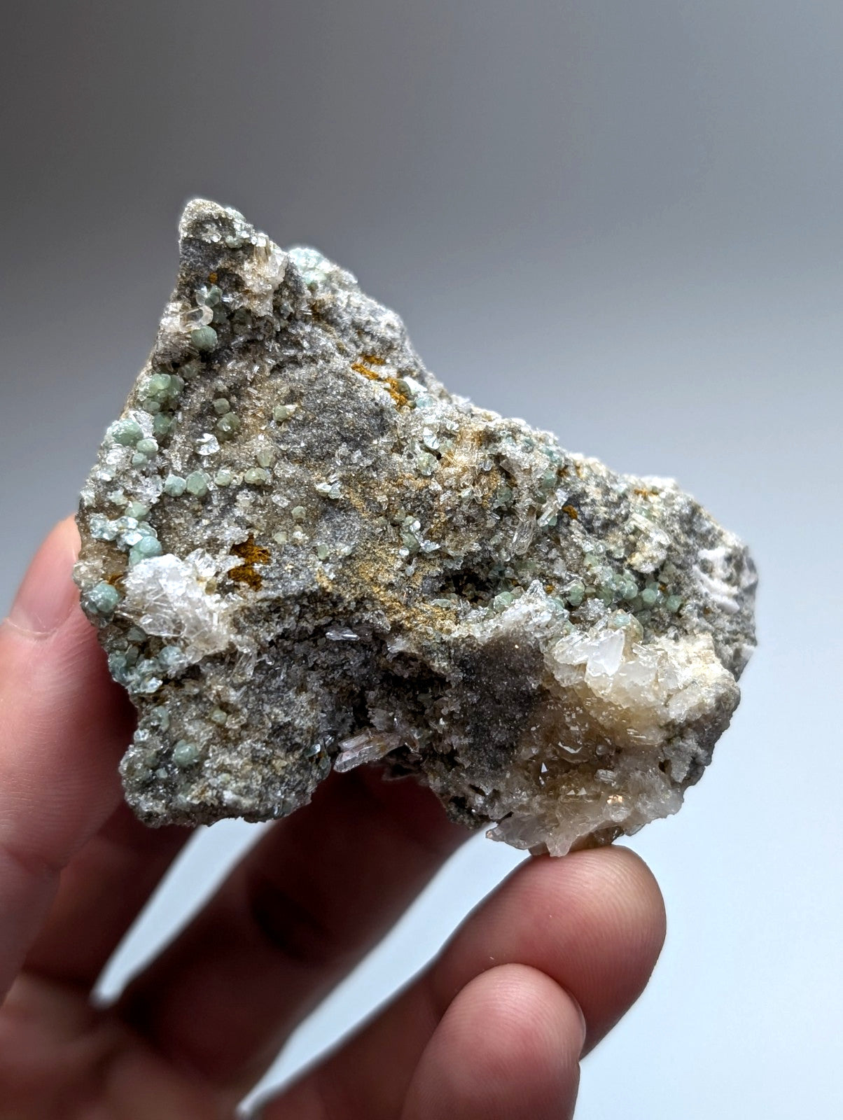 A rough blue green cookeite on quartz specimen with gray matrix and translucent white crystals from saline county arkansas