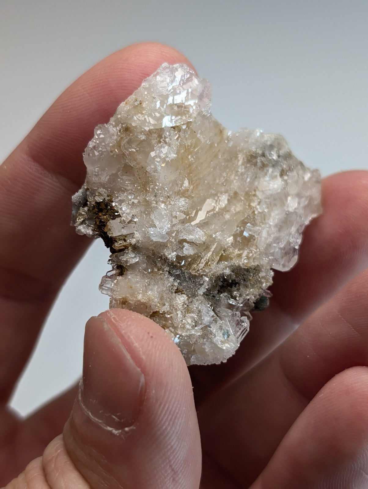 A translucent blue green cookeite on quartz with rough surface and subtle golden yellow inclusions from Arkansas