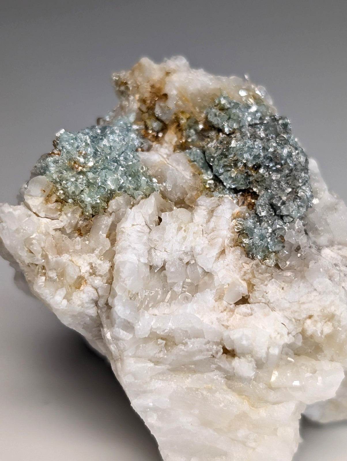 Blue green cookeite on quartz with shimmering crystals and golden metallic inclusions from saline county Arkansas